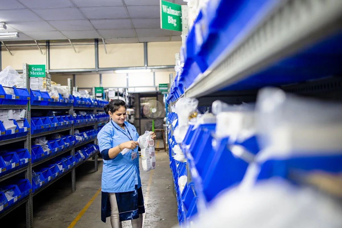 Warehouse worker checking labels as part of product data and packaging version control